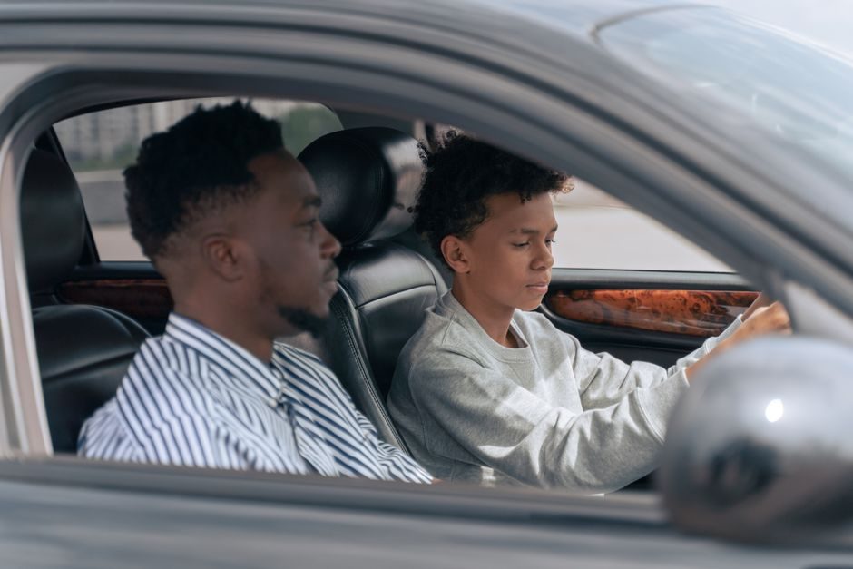 Instructor and student sitting in a car during a driving lesson