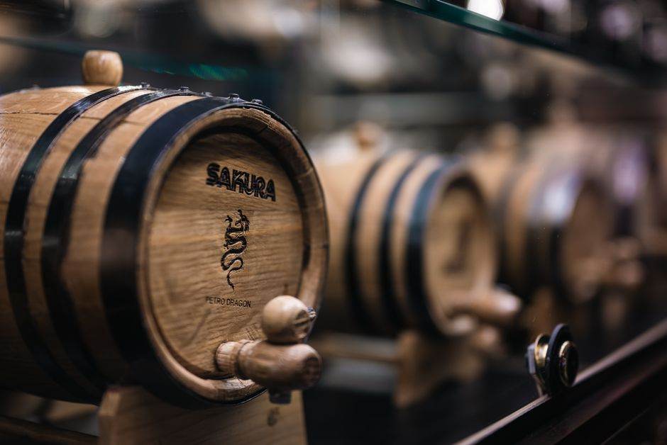 Oak barrel with a tap in a distillery cellar