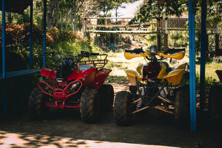 Red quad bike parked in the shade