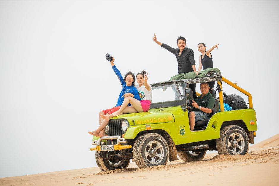 Off-road jeep driving a dirt trail along the coast